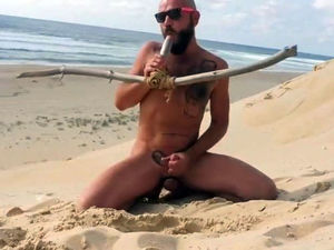 pokes himself on the beach with a wooden